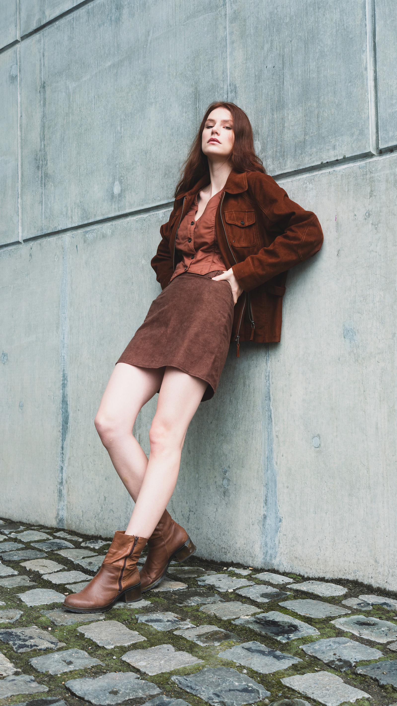 woman leaning on a wall