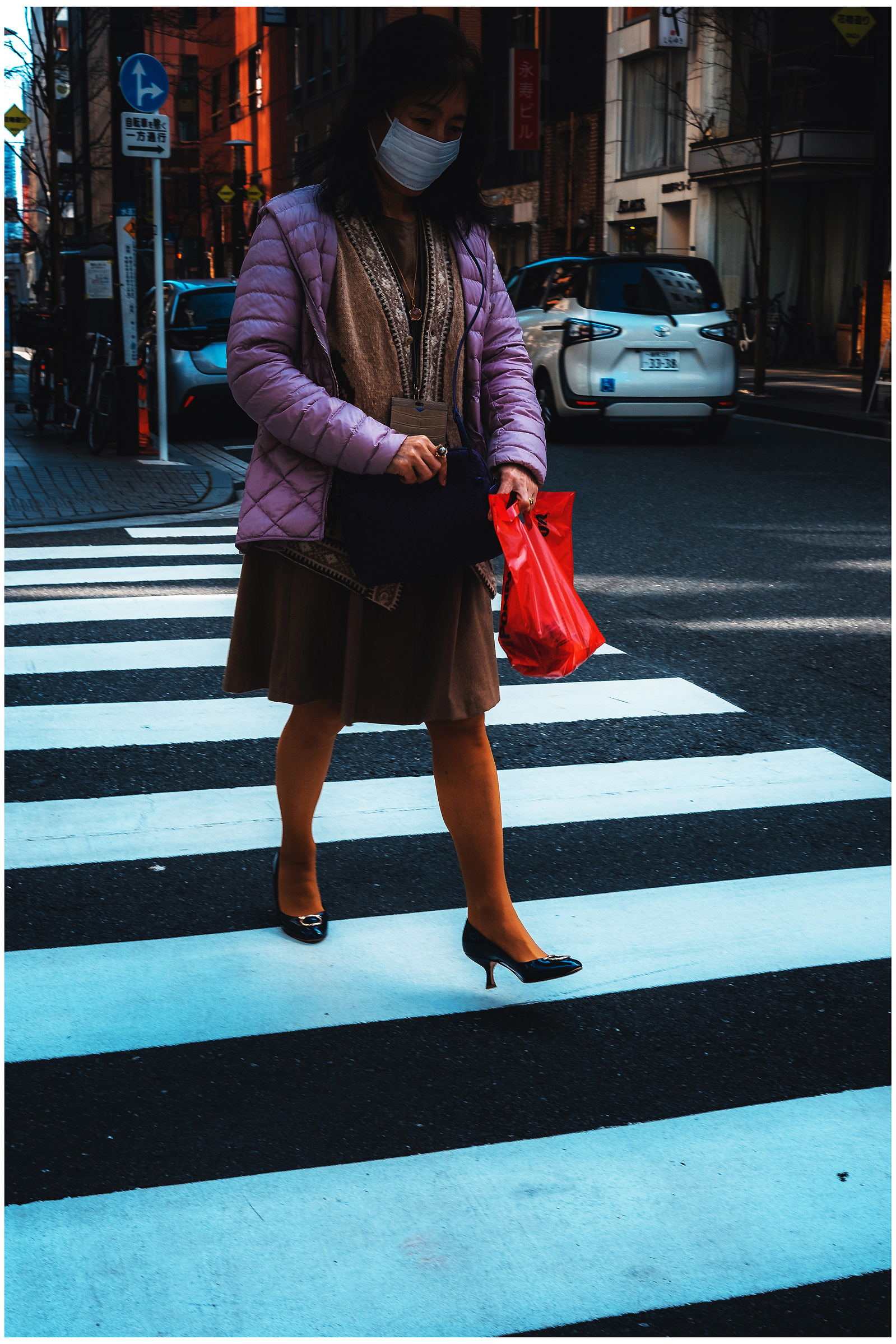 A woman walking across the street