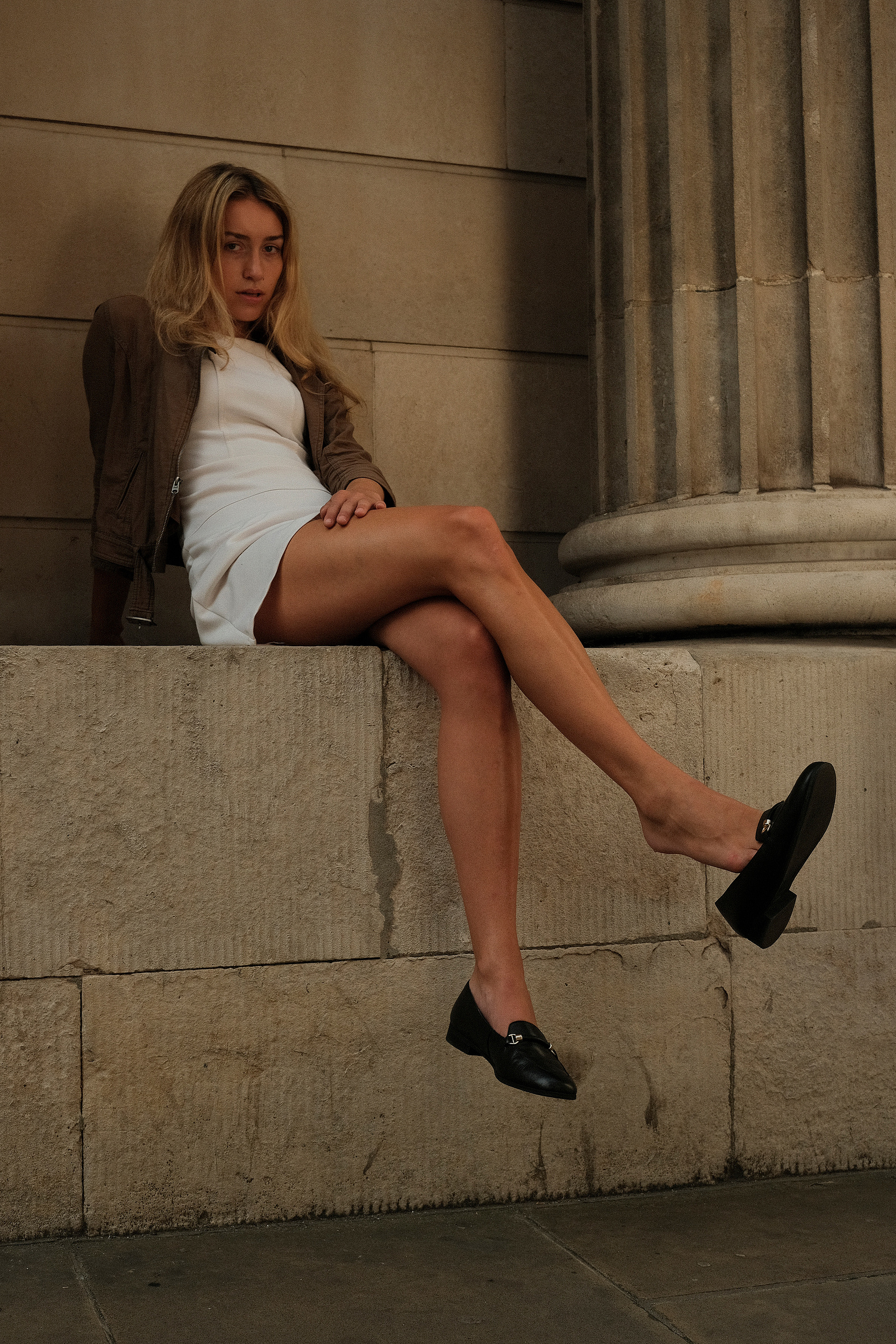 woman seated on a wall