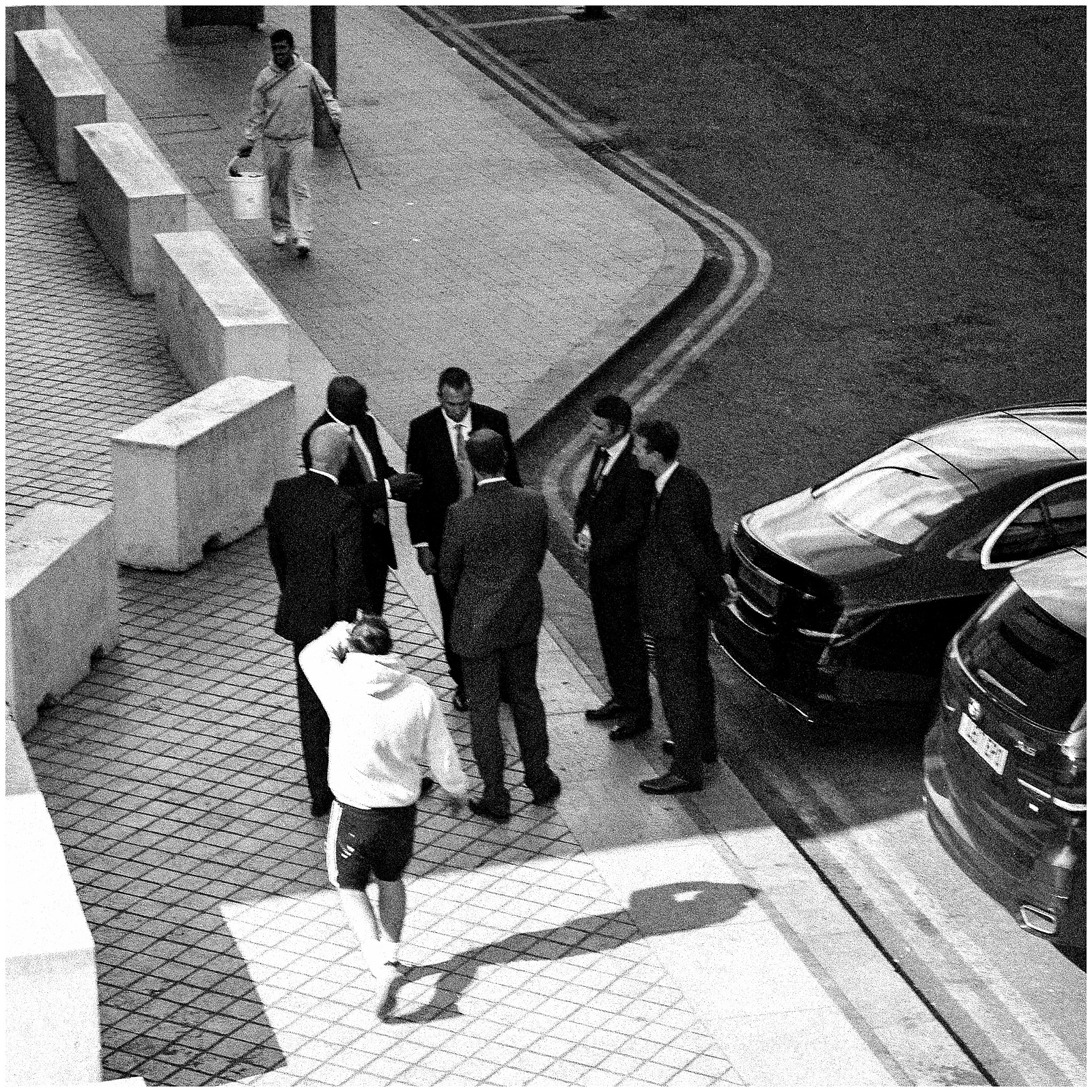 A group of men in suits having a meeting outside.