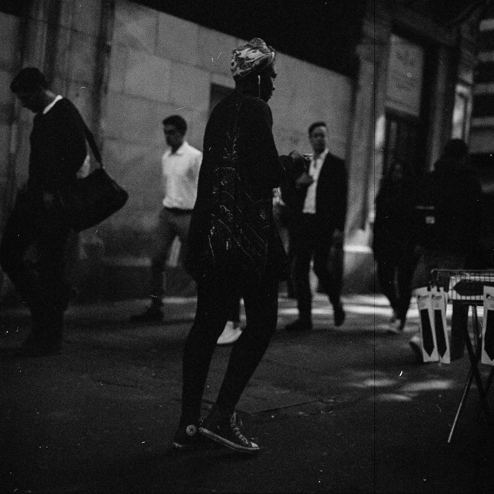 A woman silhouettes amongst the crowd