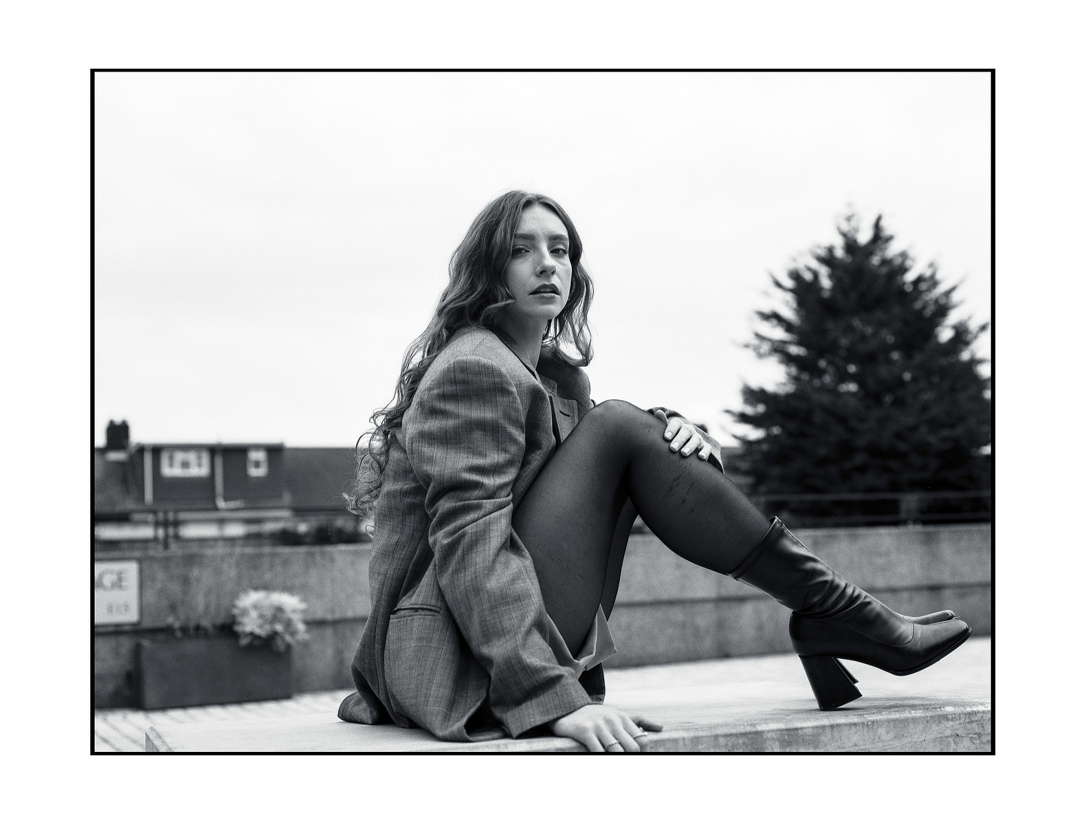 Woman seated on a concrete chair