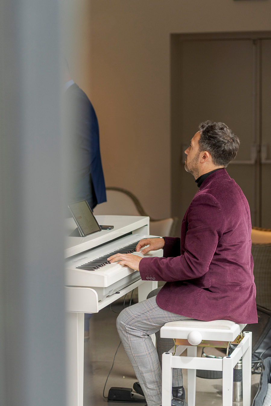 person sat at piano playing