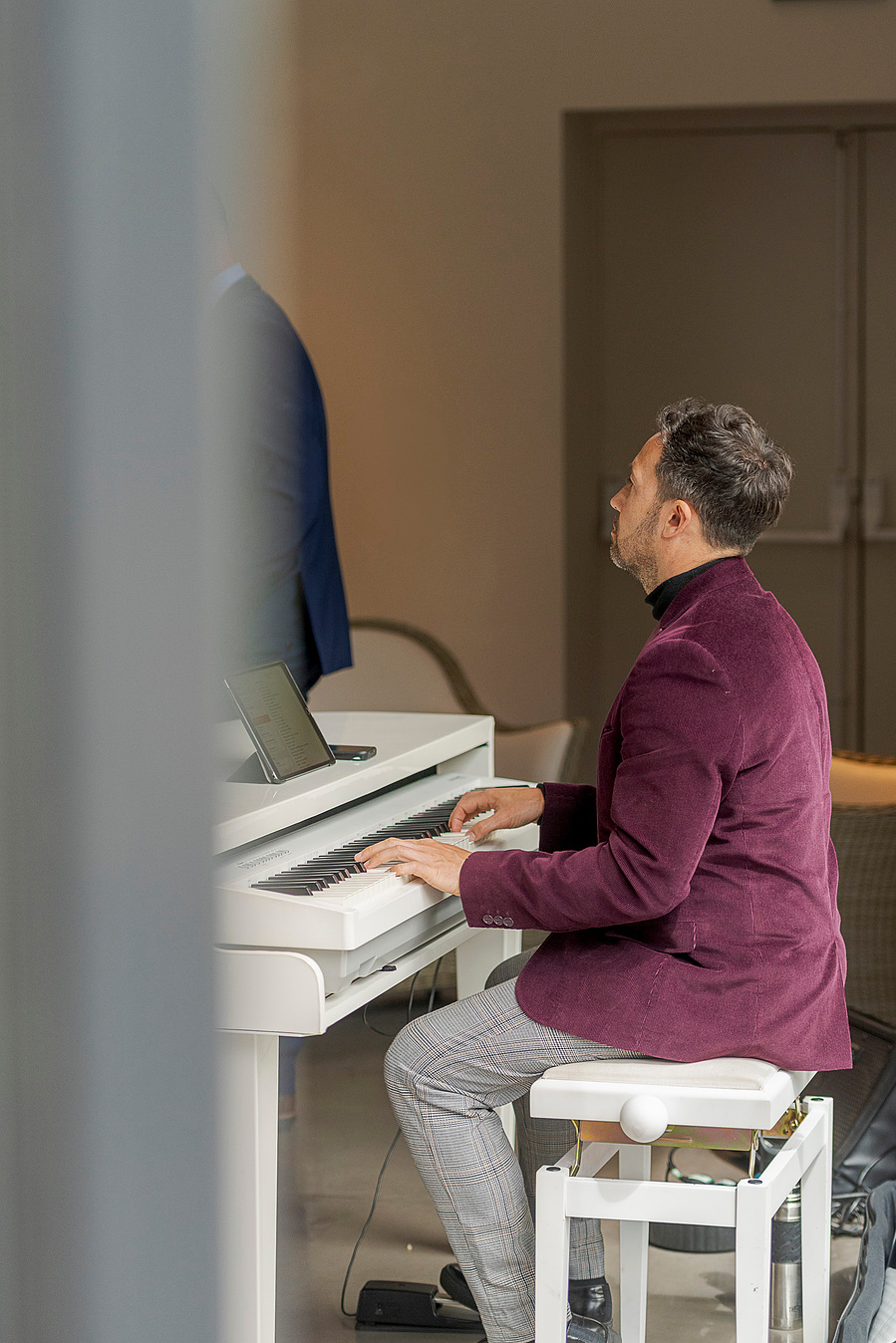 person sat at piano playing