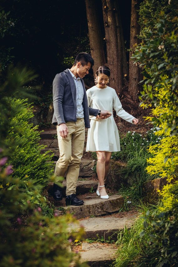 candid and natural wedding photography, city centre urban wedding, wedding couple, engagement shoot, couple walking and smiling in garden setting
