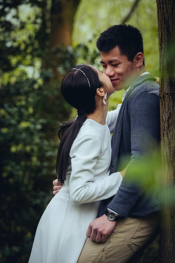 candid and natural wedding photography, city centre urban wedding, wedding couple, engagement shoot, couple hugging and laughing under blossom trees