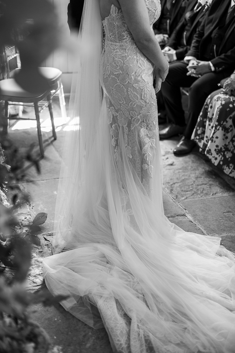 natural and authentic wedding photography, black and white shot of bride's dress flowing