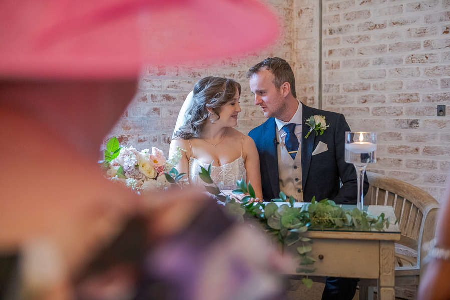 natural and authentic wedding photography, bride and groom sat at table at wedding
