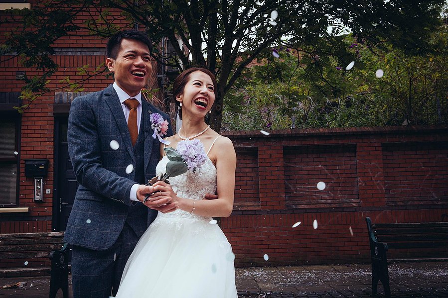 candid and natural wedding photography, city centre urban wedding, wedding couple laughing as confetti thrown at them