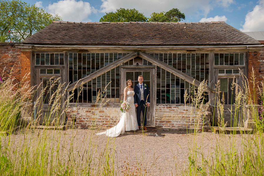 natural and authentic wedding photography, bride and groom in front of vintage greenhouse
