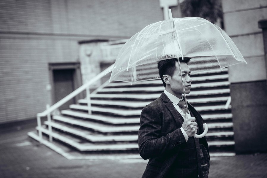 candid and natural wedding photography, city centre urban wedding, groom holding umbrella