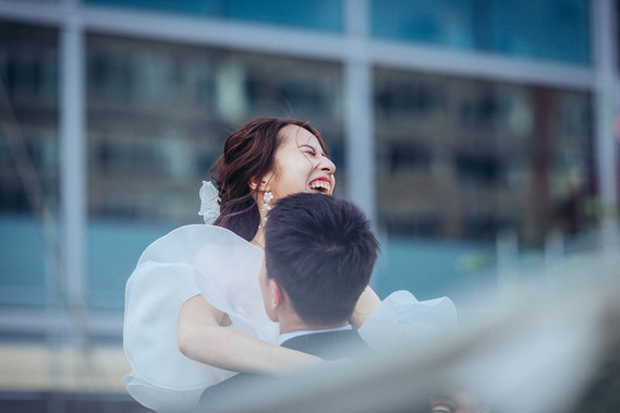 wedding photography, bride and groom portrait, groom lifts up bride as she laughs