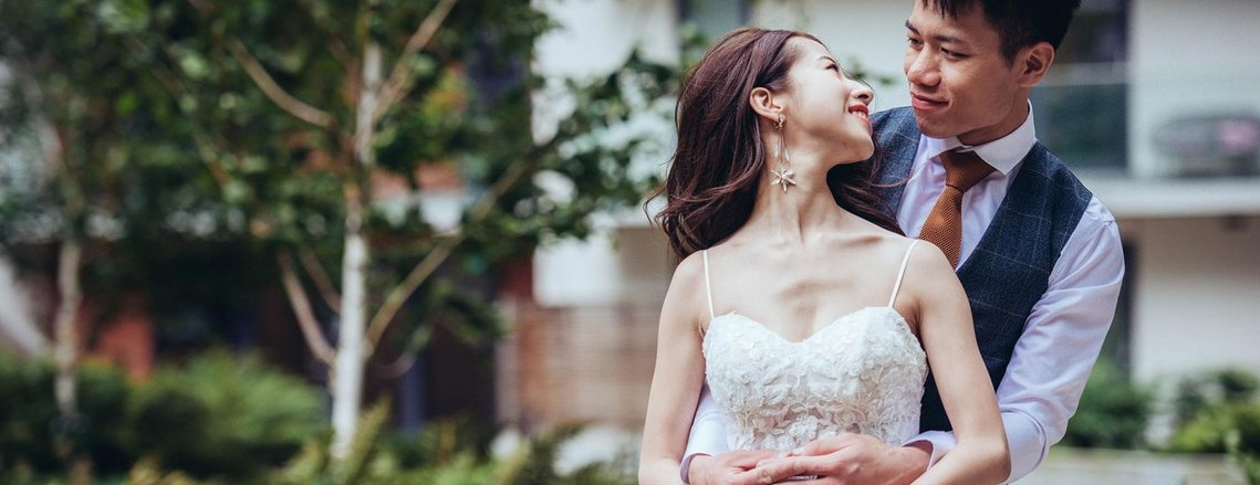 candid and natural wedding photography, city centre urban wedding, couple hug and pose for photo in their wedding outfits