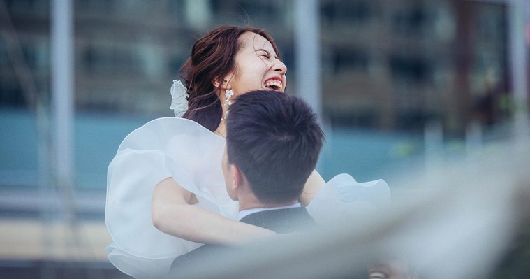 candid and natural wedding photography, city centre urban wedding, wedding couple laugh and hug