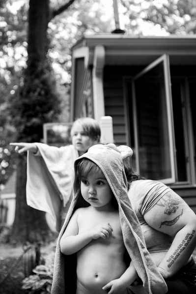 artistic documentary photo in black and white of children playing make believe