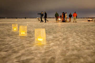 Luminaries line a walk on the frozen Lake Mendota.