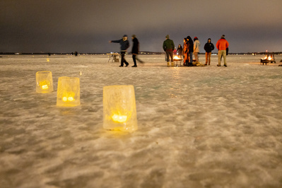 Luminaries line a walk on the frozen Lake Mendota.