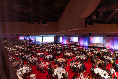 Overview of a full room of tables at the Monona Terrace for an event. 