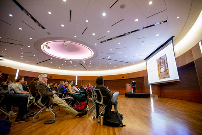 A person is talking in a room in the Discovery building. 