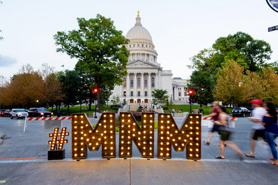 The Madison Night Market "MNM" letters are on displayed in front of the Capitol. The big letters are there for people to pose in front of. 