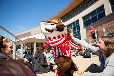 Bucky badger gives a high schooler a high five! 