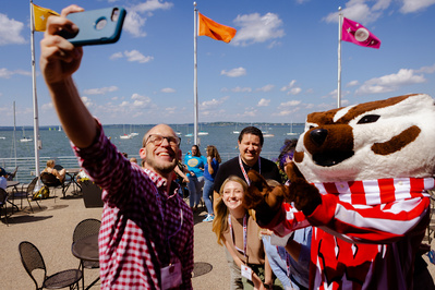 A group of students pose with Bucky Badger at the Memorial Union at the UW Wisconsin on a nice summer day. 