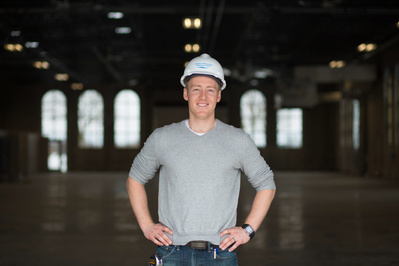 A man is wearing a hard hat. 