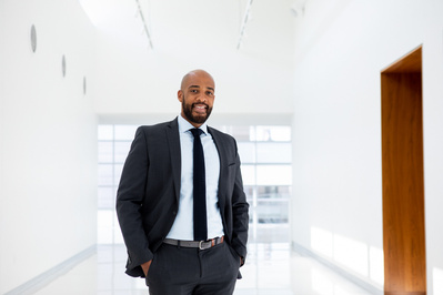 Mandela Barnes has his hands in his pockets and is sorta smiling at the Madison Library. 