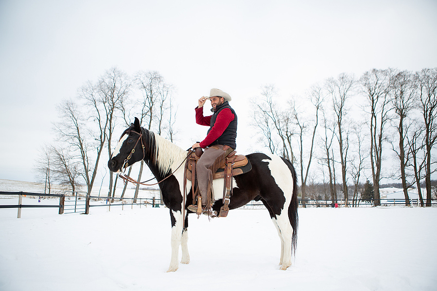 A cowboy is on his house on a snowy day. It's a nice contrasty photo. This cowboy was a real dick. 