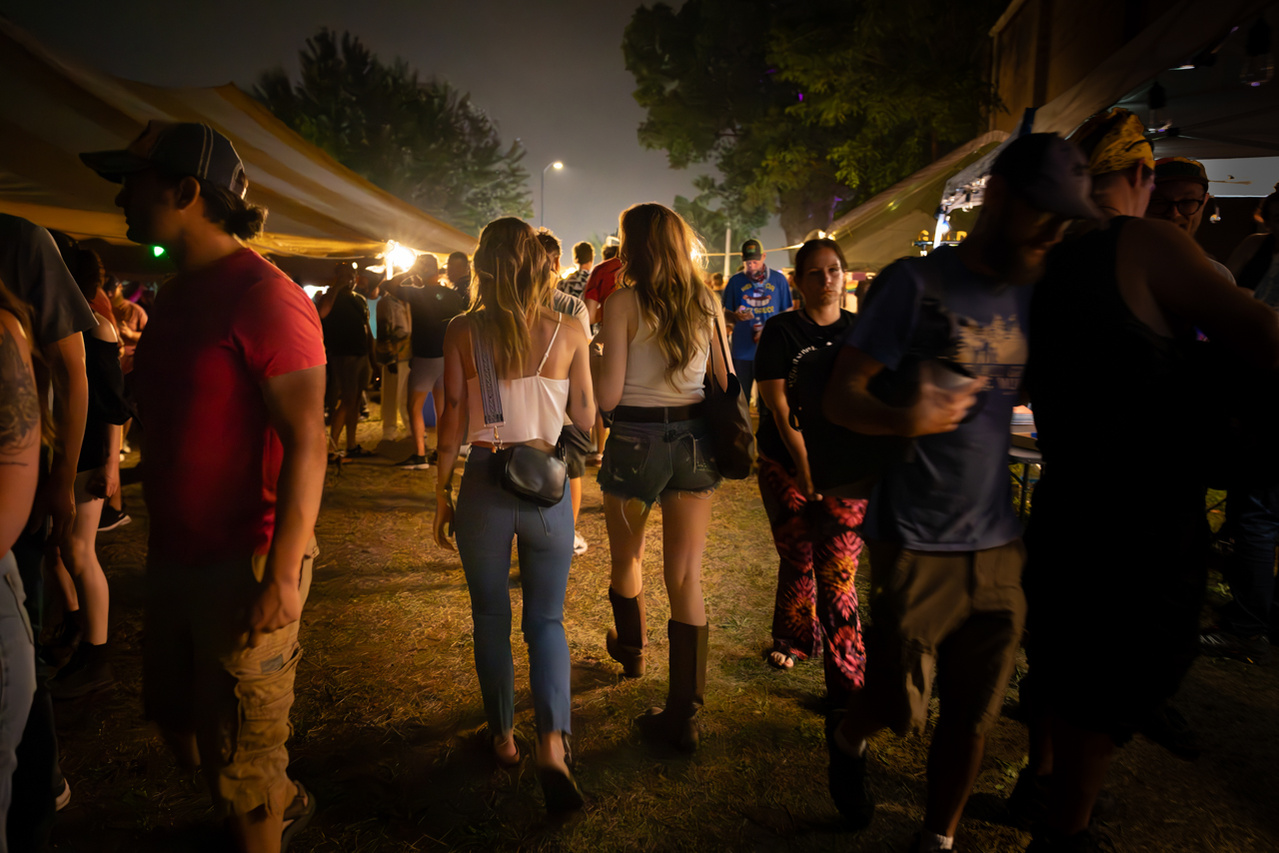 A young couple mingles among a crowd of revelers at the Dane County Fair in this event photograph at the Alliant Energy Center in Madison, WI.