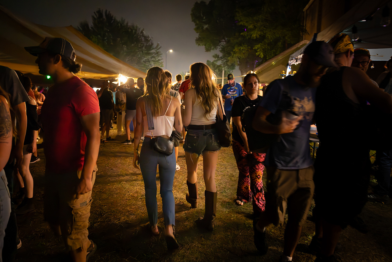 A young couple mingles among a crowd of revelers at the Dane County Fair in this event photograph at the Alliant Energy Center in Madison, WI.
