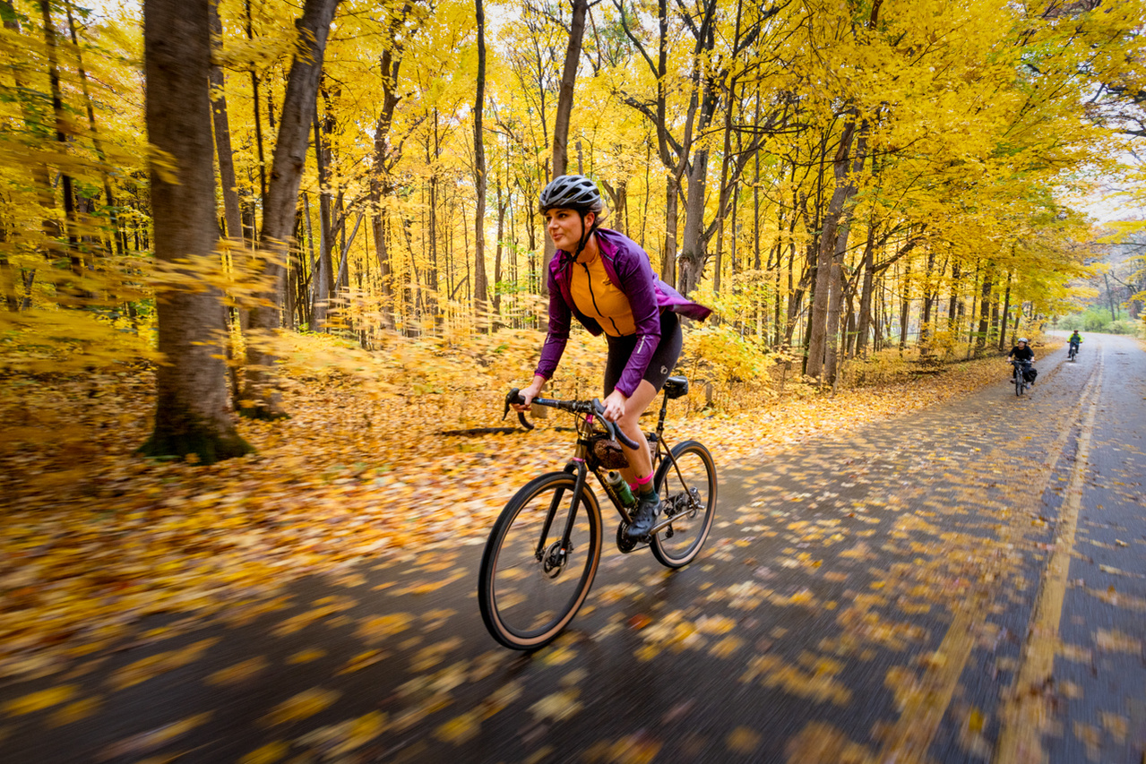 Commercial photograph of Autumn biking in the Arboretum of Madison, Wisconsin. The University of Wisconsin Arboretum glows with Fall color as the leaves change with the season.