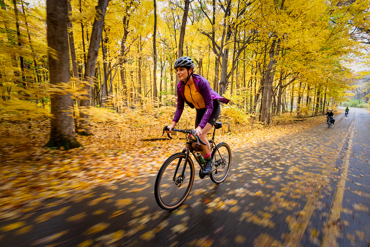 Commercial photograph of Autumn biking in the Arboretum of Madison, Wisconsin. The University of Wisconsin Arboretum glows with Fall color as the leaves change with the season.