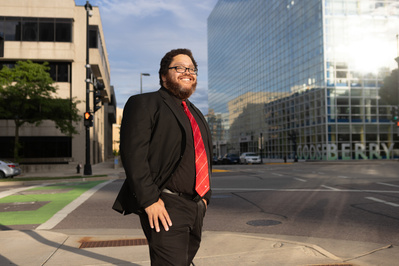 A guy is standing in the street. 