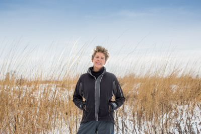 A women stands in a field. 