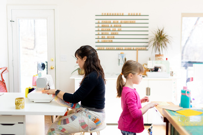 A Mother and Daughter are crafting in their bright art room in this family documentary photo.