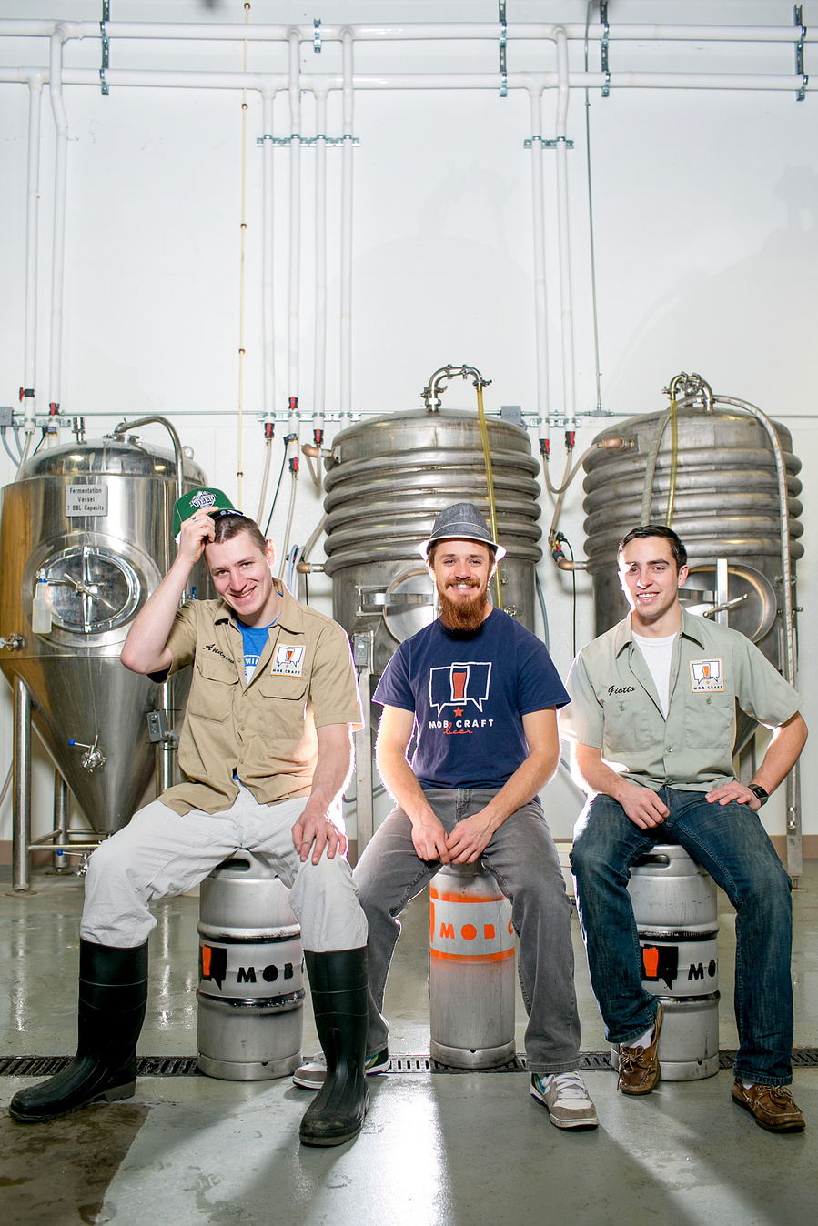 Three brewers pose in front of the tanks that house the beers. I don't think this brewing company is still in business. 