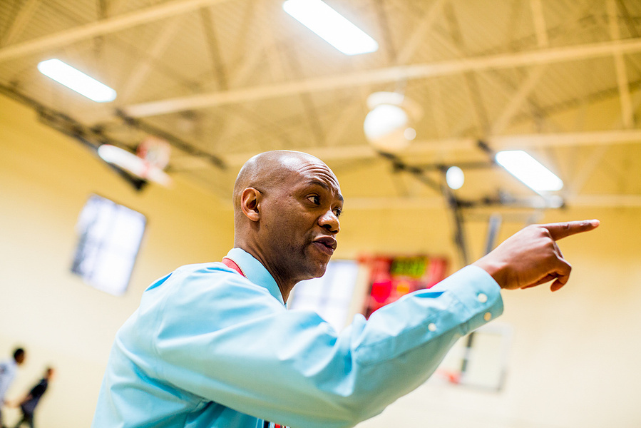 A basketball coach is pointing his finger to make a point to the kids he is teaching. I liked this guy a lot. 
