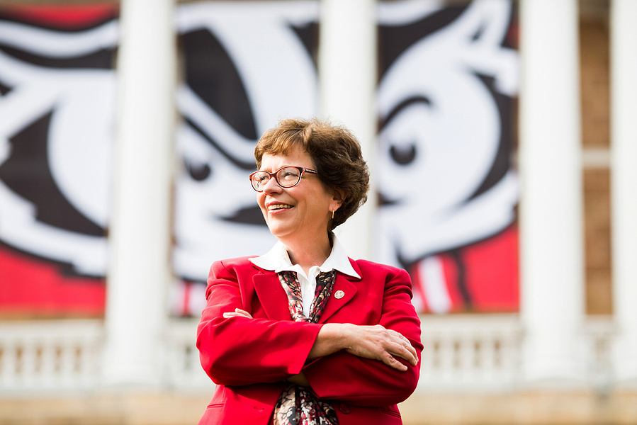 Rebecca Blank, The former Chancellor at the UW Madison, is posed in front a building on Bascom hill. 