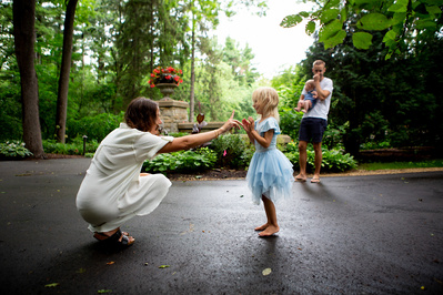 after a rainy day a family enjoys time in the park in a documentary style photo