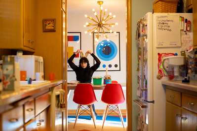 coming of age photography of a child playing in their dining room