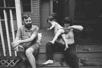 A beautifully candid photo of a family on their porch. 