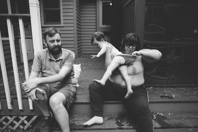 A beautifully candid photo of a family on their porch. 