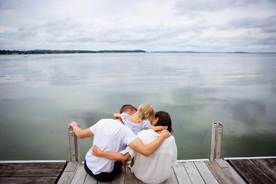 candid portrait of a family enjoying time together on a dock on lake monona