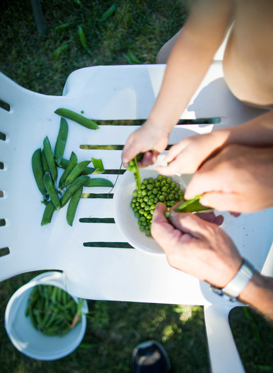 a granddaughter and grandfather enjoy the garden together in this documentary photo