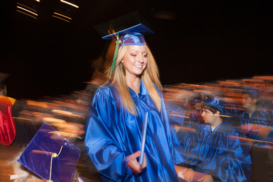A Madison College student accepts her diploma. 