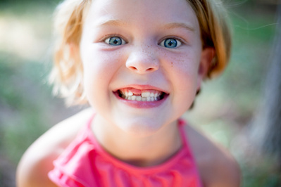 coming of age photography w child showing she has lost her front tooth madison, wi