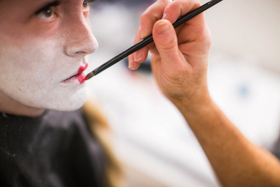 A behind the scenes photo at the hair affair at the MMoCA event a gal is getting her lips done.