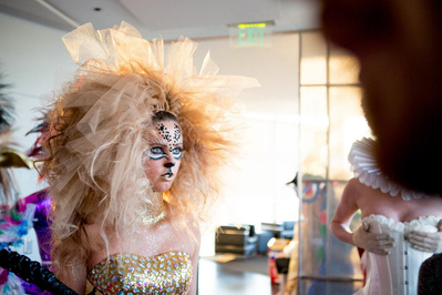 a behind the scenes photo at the event Hair affair. A gal is dressed up to to look like a fierce lion. 