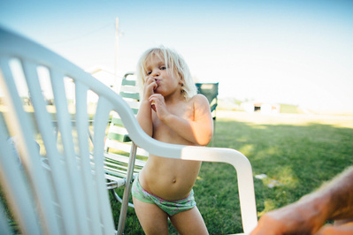 a fun funky kid enjoys a summer day in this family portrait